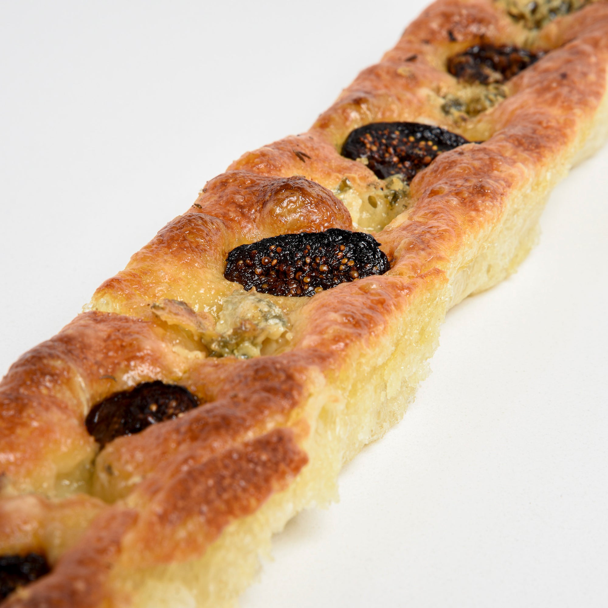 Close up of Le fournil bakery baguette méditerranéenne italian style bread with figs and blue cheese