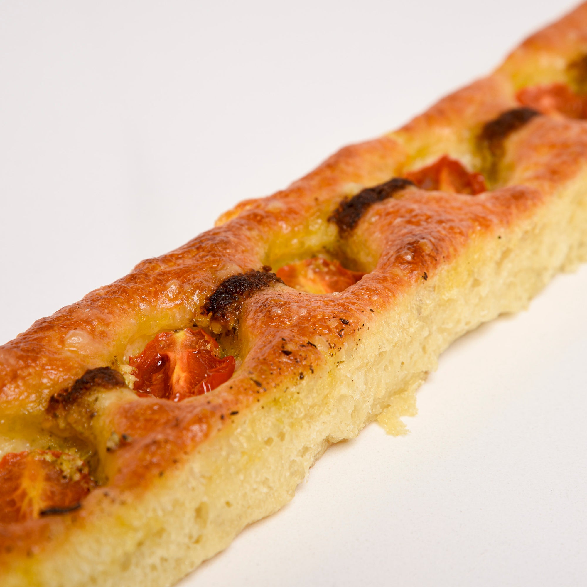 Close up of Le fournil bakery baguette méditerranéenne italian style bread with tomato and pesto