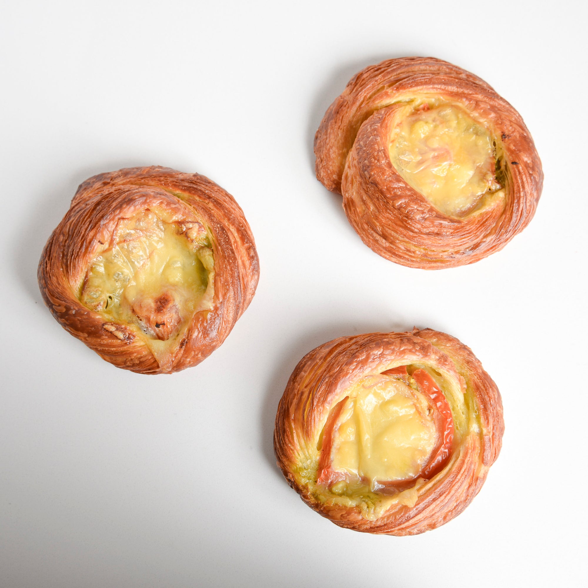 Group of Le fournil bakery danoise salée danish filled with tomato, pesto, and smoked cheddar cheese