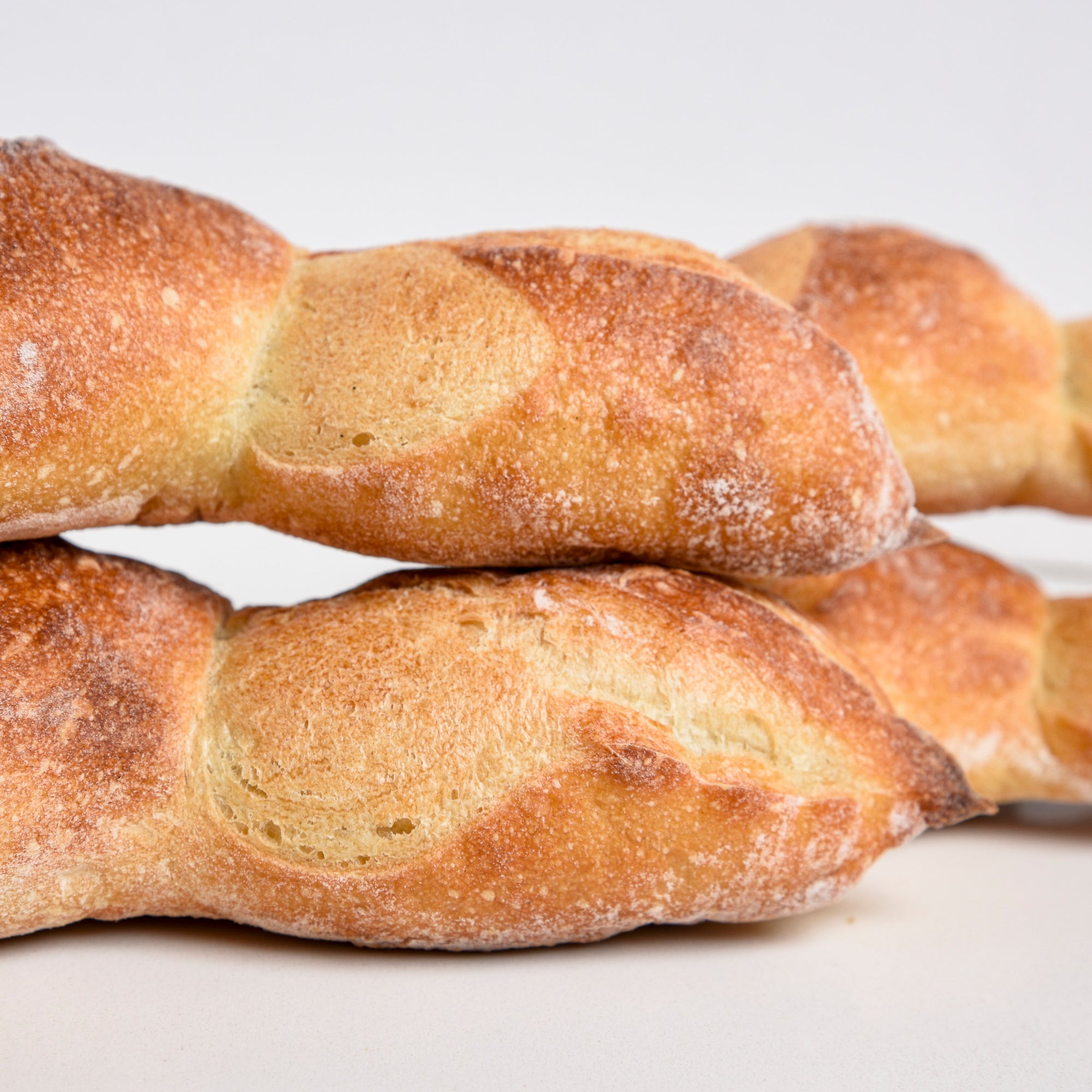 Two Le fournil bakery épi baguettes stacked
