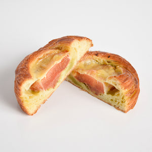 Cross section of Le fournil bakery danoise salée danish filled with tomato, pesto, and smoked cheddar cheese