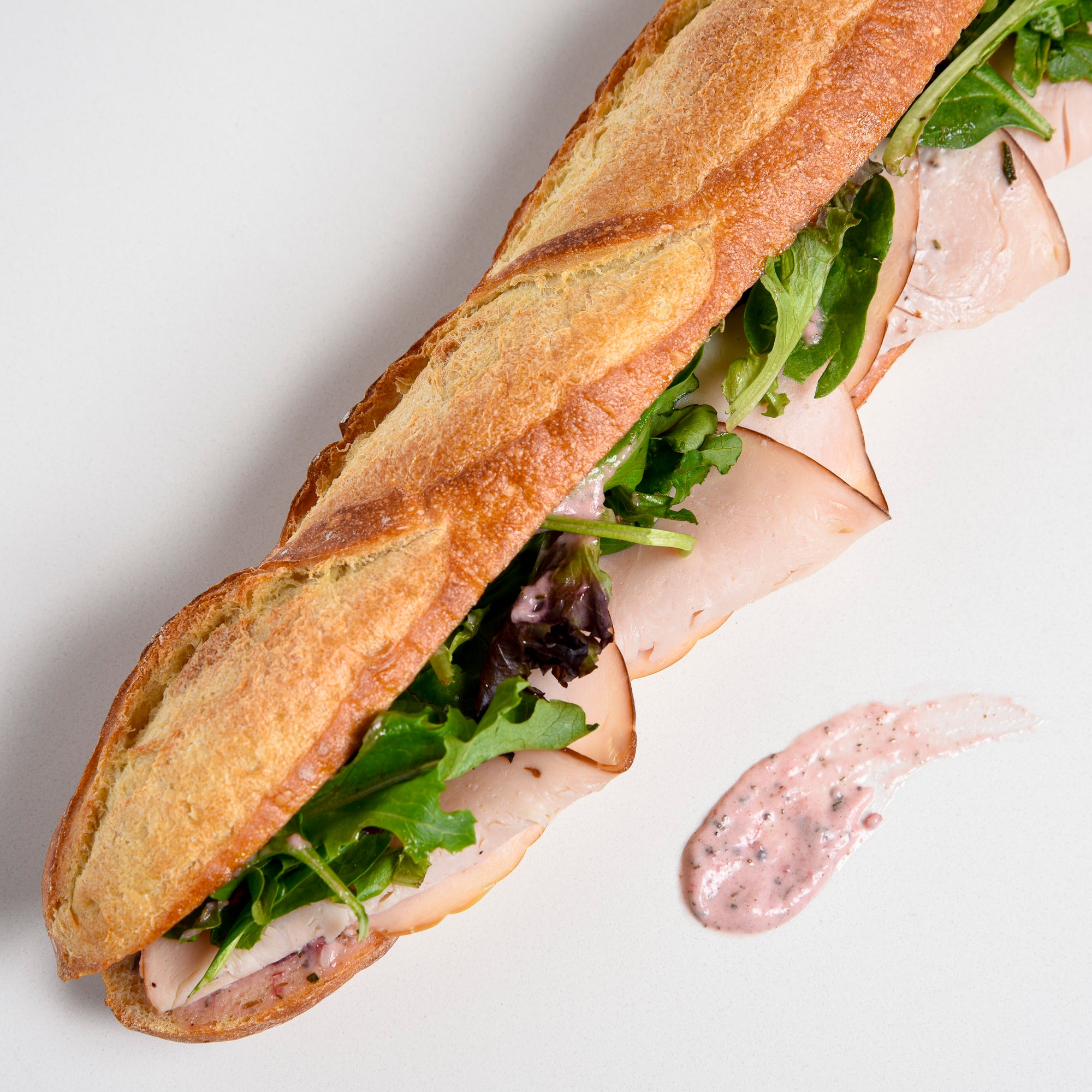 Le fournil bakery sandwich dinde canneberges smoked turkey with cranberry mayonnaise and lettuce close up